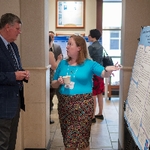 Student is presenting a poster to President T. Haas